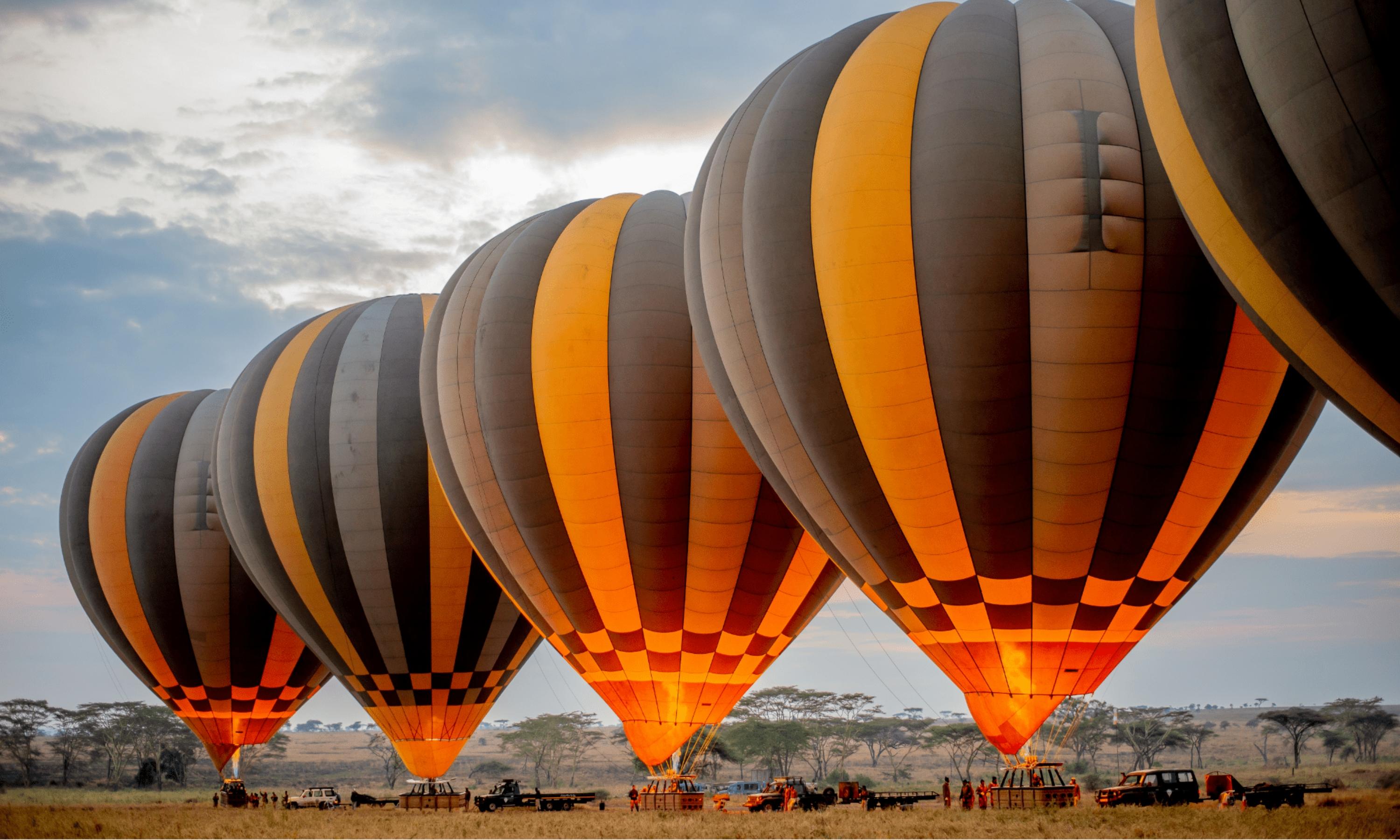 Hot air balloon being inflated on the Serengeti plains before dawn