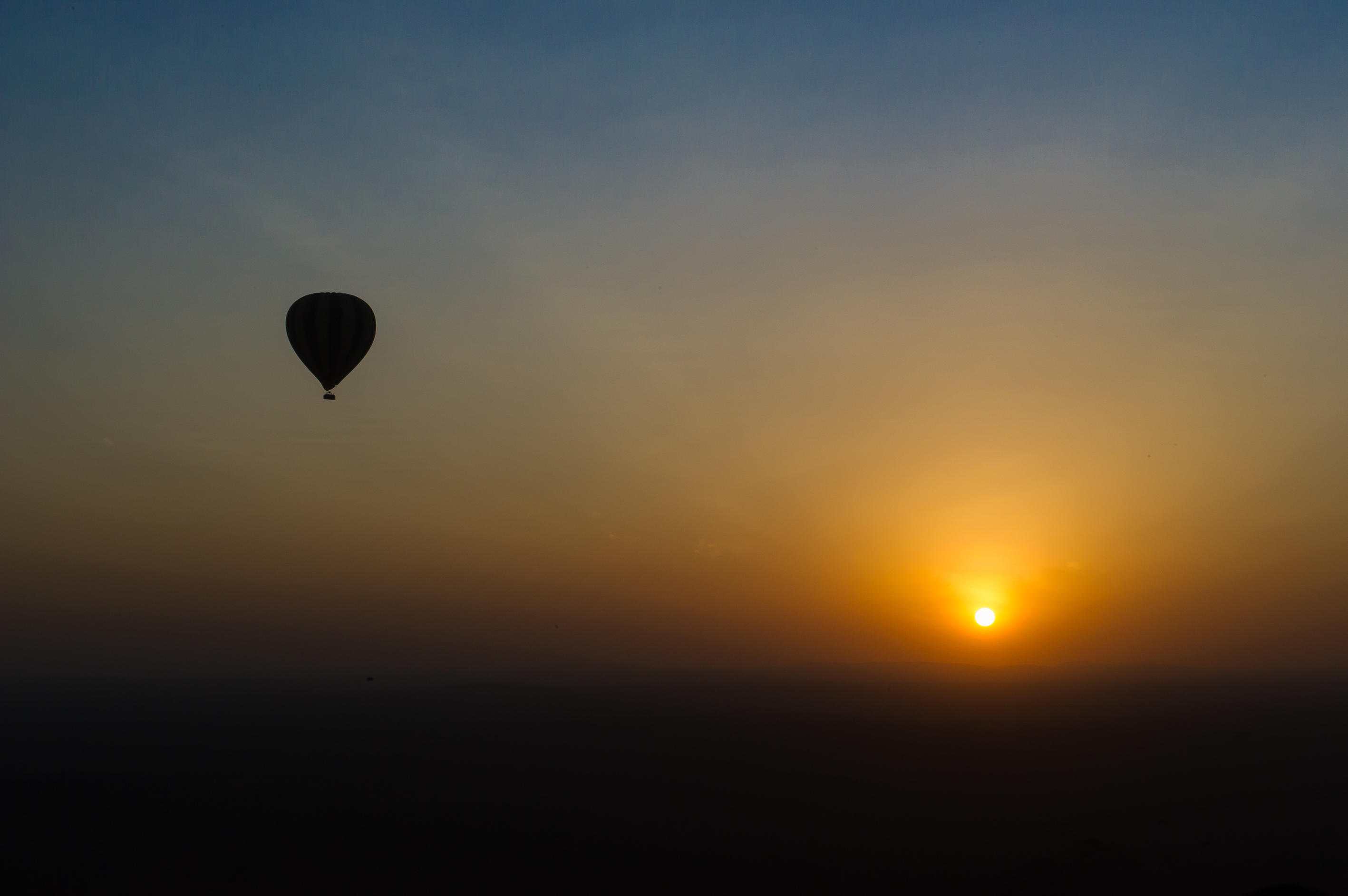 Two balloons over Tanzania at golden hour sunrise